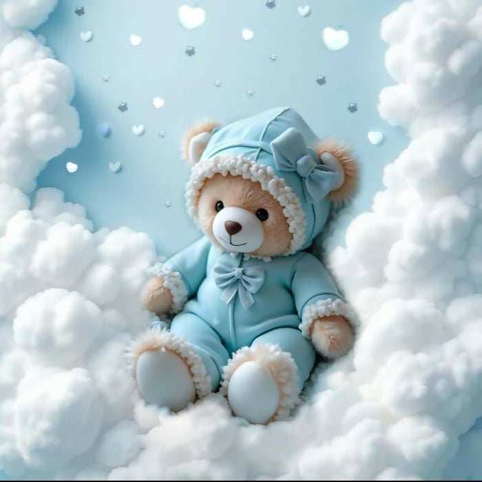 Teddy bear in a blue outfit sitting on fluffy clouds with a light blue background