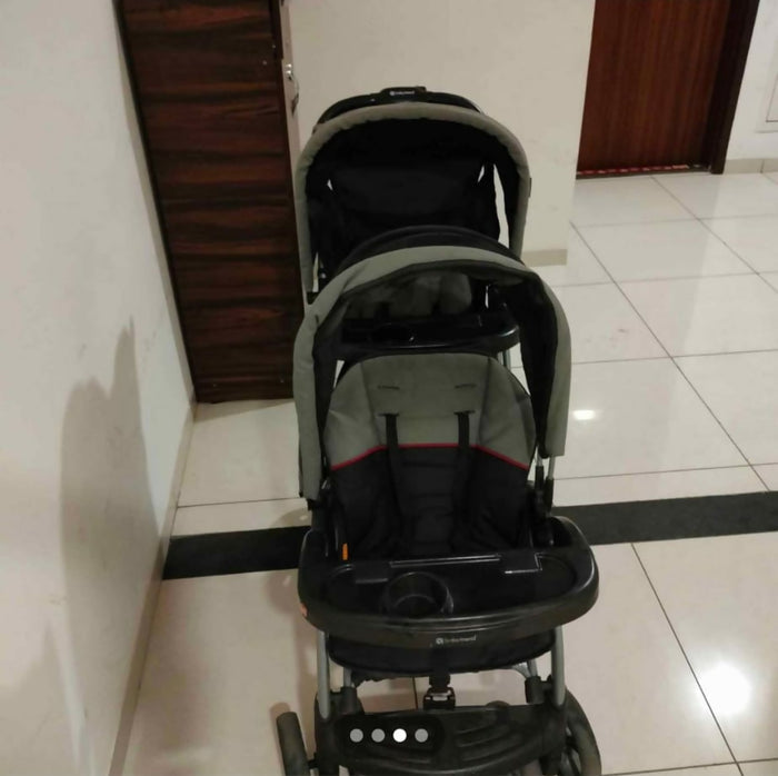 Sit & Stand Twin Baby Stroller with dual seating arrangement, sit-and-stand configuration, comfortable seats, safety harnesses, protective canopy, smooth wheels, and convenient storage for travelling with two children.