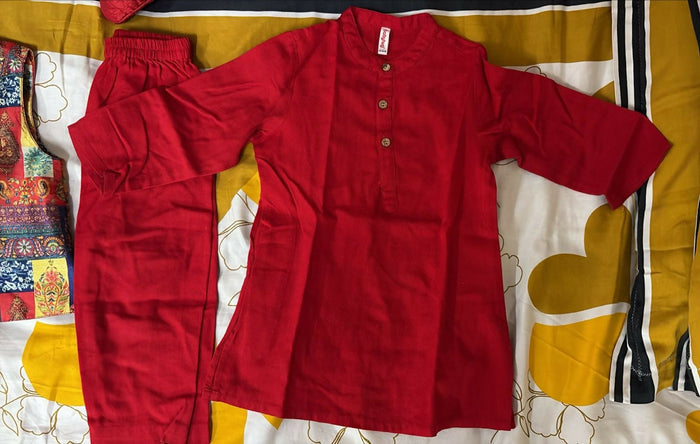 Red pants on a patterned bedspread