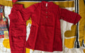 Red pants on a patterned bedspread