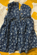 Blue dress with star and shell pattern on a yellow and white background