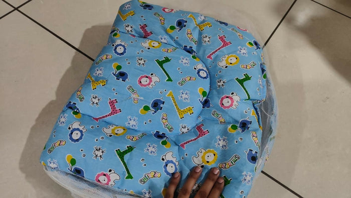 Bedding with mosquito net for newborn baby featuring a soft cushioned sleeping surface, protective mosquito net, cozy design, and comfortable support for restful sleep.