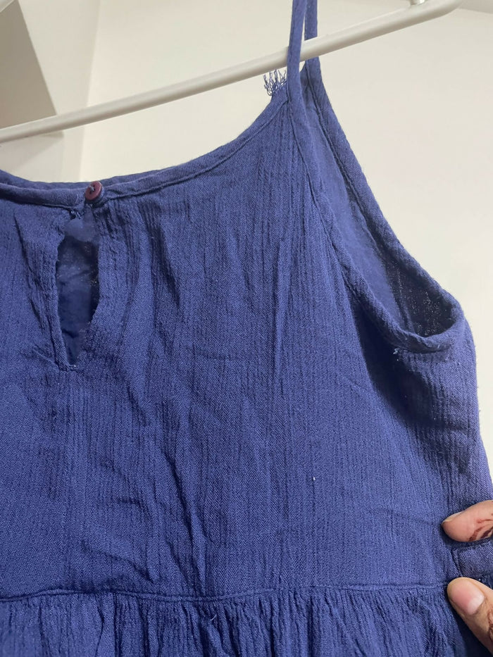 Blue dress on a hanger against a white background