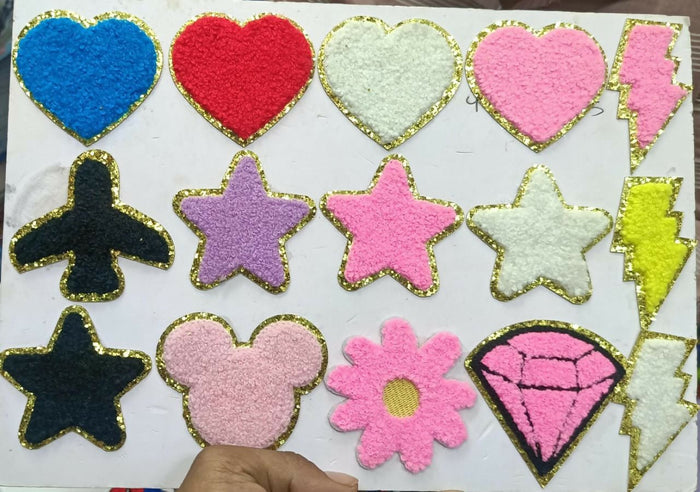 Collection of colorful heart, star, and other shaped patches on a white background.