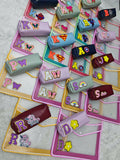 Colorful letter-shaped erasers scattered on a textured surface