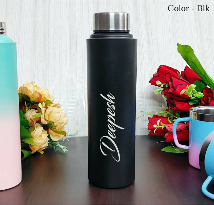 Black water bottle with 'Deepesh' branding on a wooden surface with flowers and other bottles in the background.