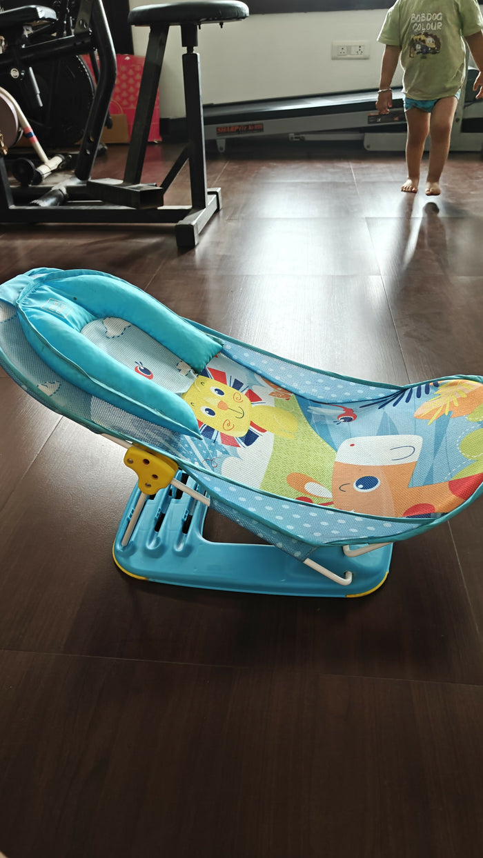 MEE MEE Baby Bather in Some Used condition featuring an ergonomic reclined design, supportive seating, comfortable fabric, and a lightweight frame for convenient supervised baby bath time.
