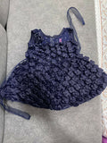 Navy blue floral dress with a matching headband on a gray surface
