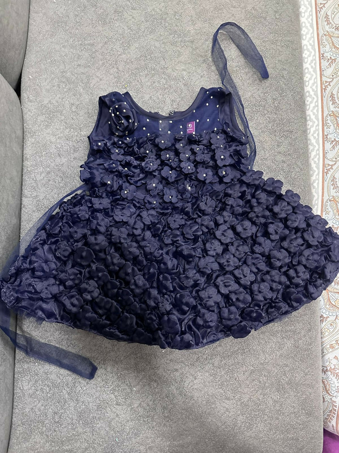 Navy blue floral dress with a matching headband on a gray surface
