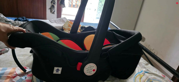 R FOR RABBIT Picaboo Baby Carry Cot/Car Seat in Almost New condition with comfortable padded seating, safety harness, ergonomic carry handle, protective canopy, and versatile design for convenient infant travel.