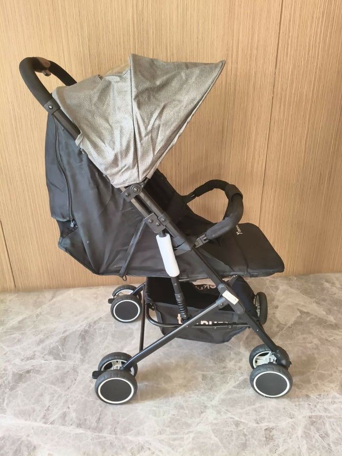 Black stroller with a beige canopy