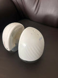 Théa wearable electric breast pump with hands-free design, compact milk collection cups, adjustable suction, and portable pumping support for breastfeeding mothers.