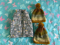 Floral-patterned pouches and a yellow textured bag on a blue fabric background with butterfly designs.