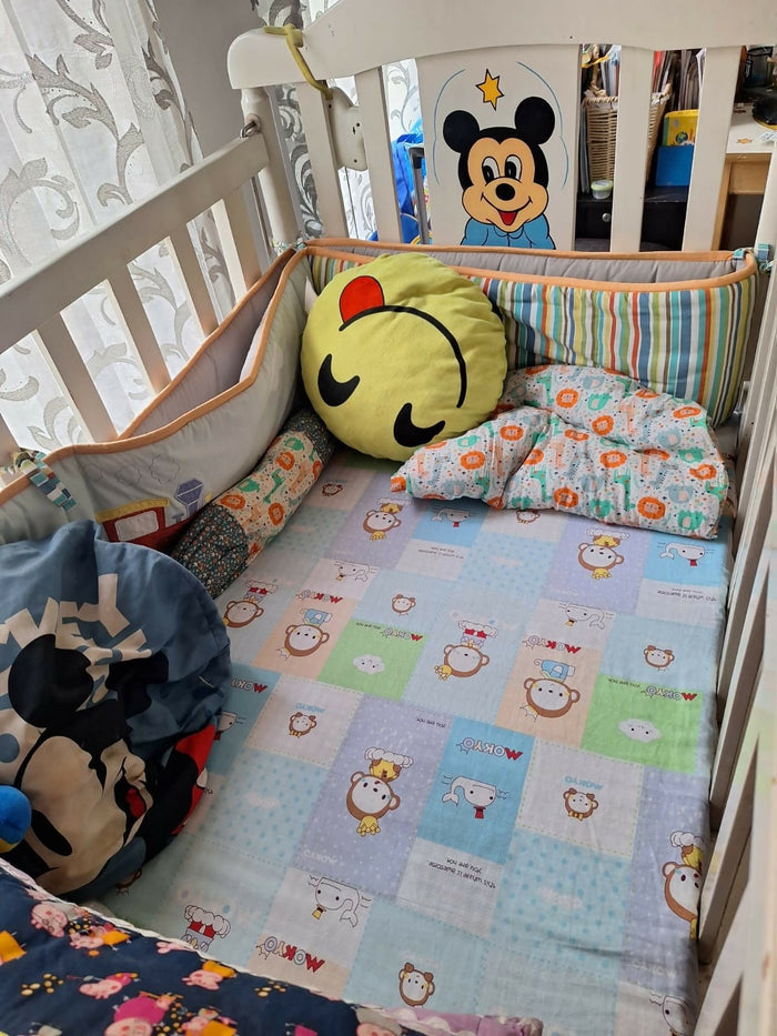 Wooden baby crib with storage, mattress, and bumper featuring sturdy wooden construction, spacious sleeping area, built-in storage, protective bumpers, and comfortable support for babies.
